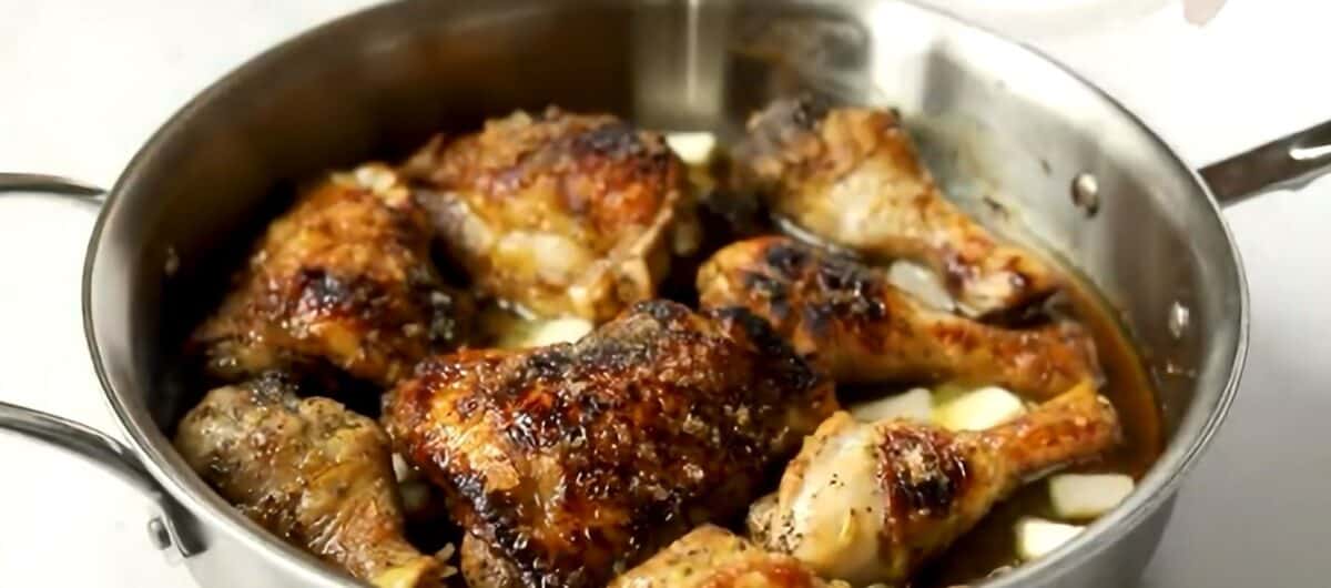 Chunks of butter melting in the skillet with the chicken.