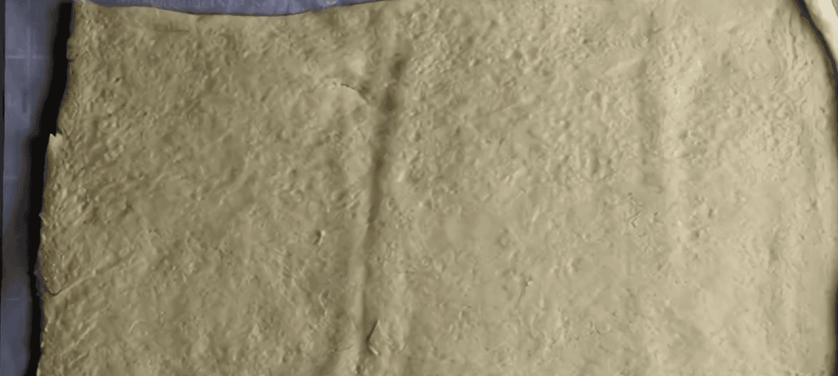 Crescent roll dough laid out flat. 