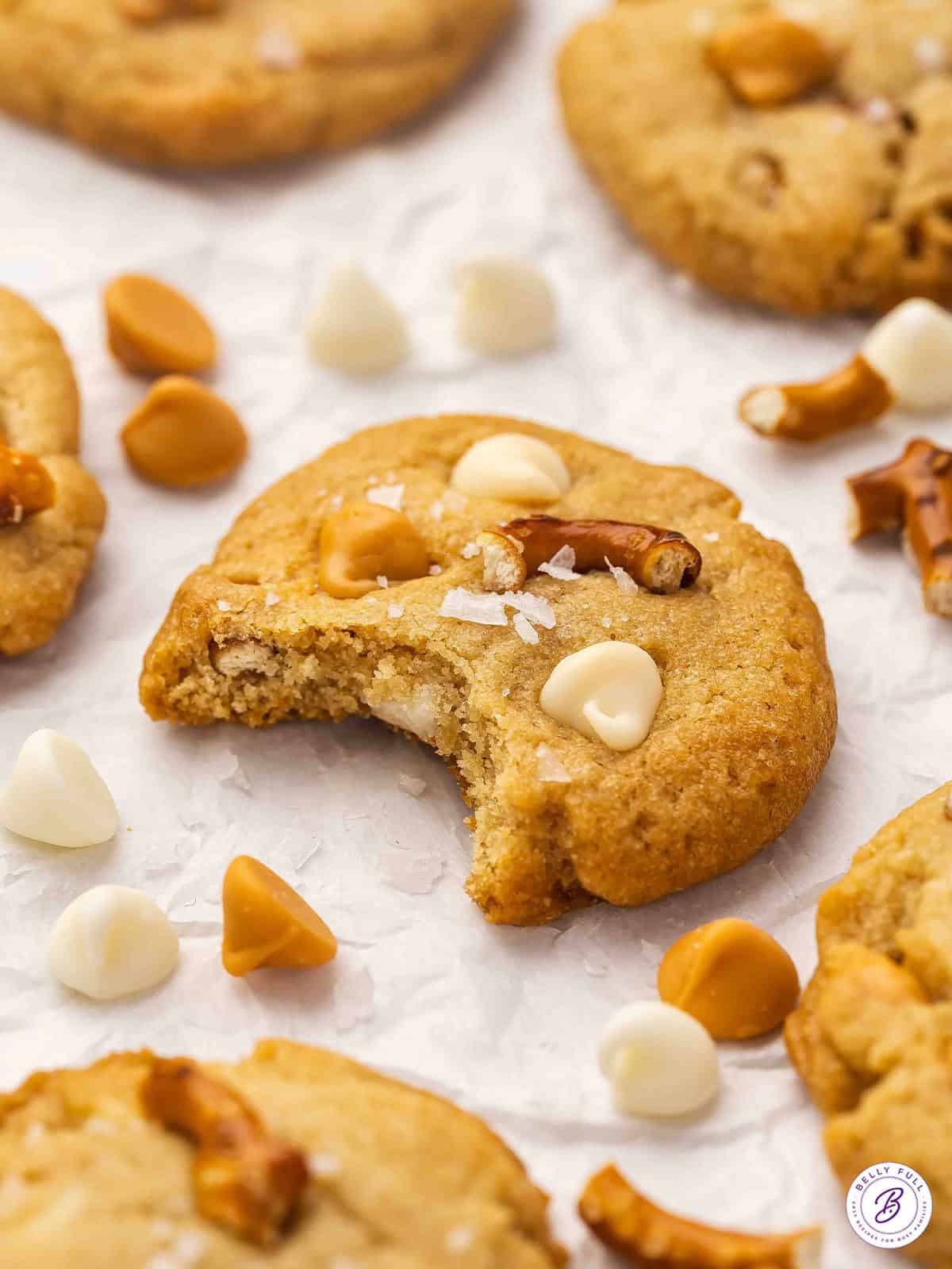 A butterscotch pretzel cookie with a bite missing