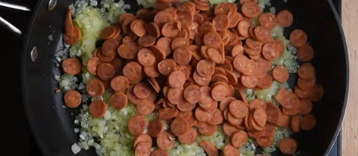 Sauteeing onions and pepperoni.