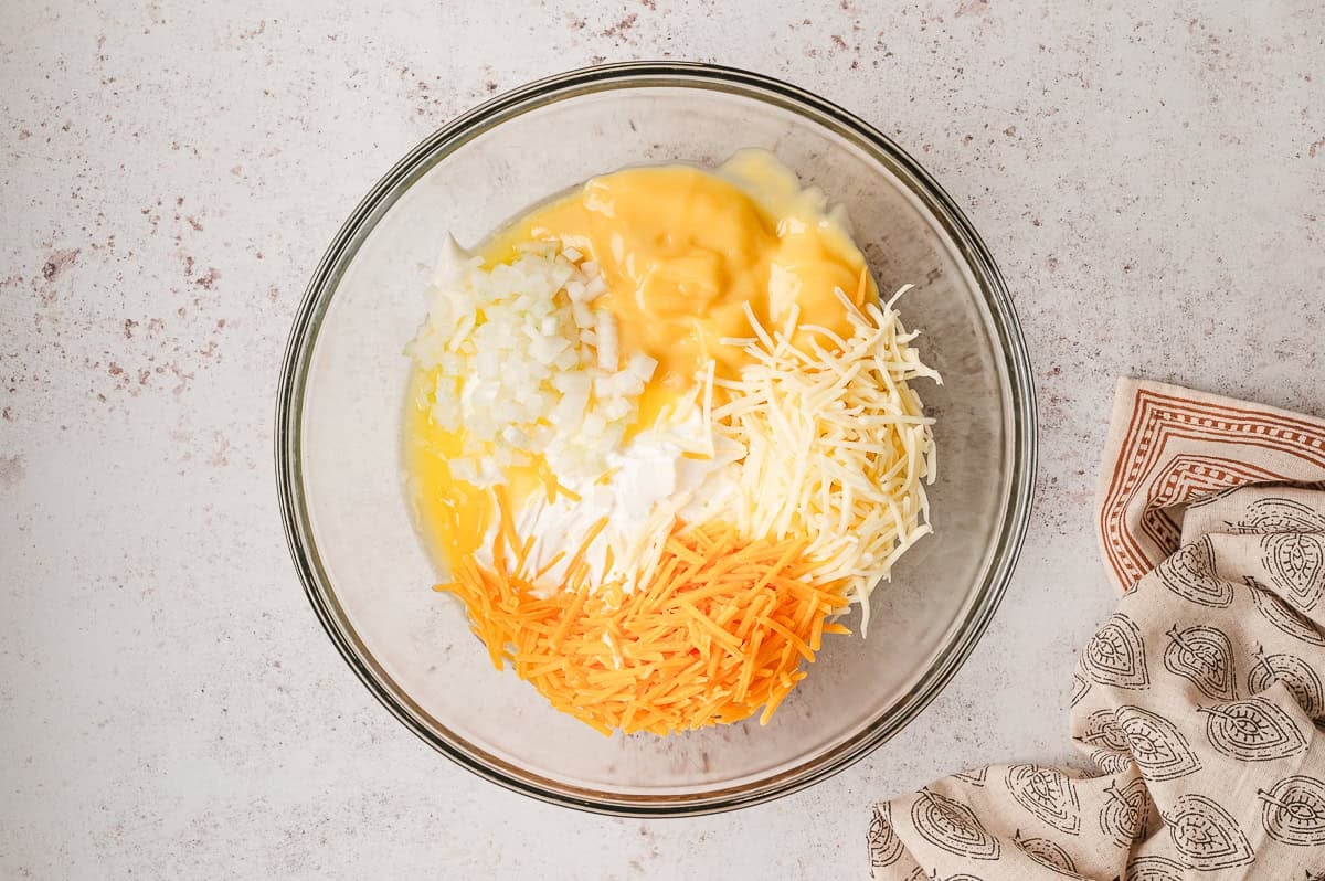 Glass bowl of cheese filling for funeral potatoes.