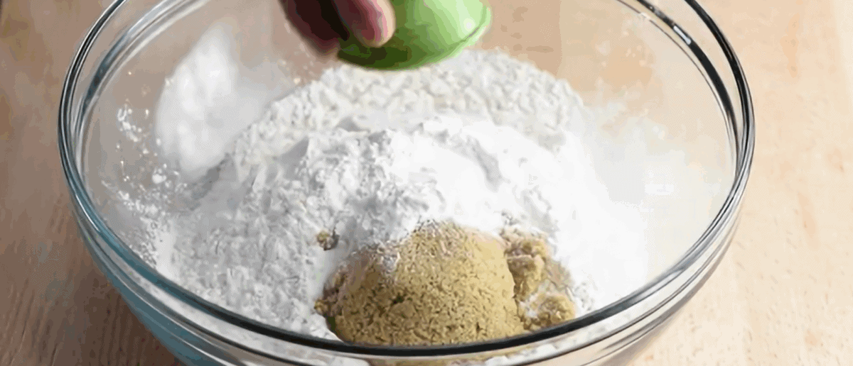 Preparing the batter for the beer bread in a glass bowl.