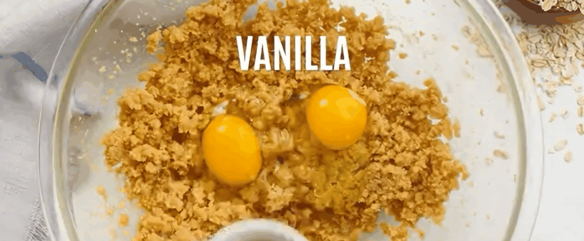 Creamed butter and sugar with eggs in a glass bowl.