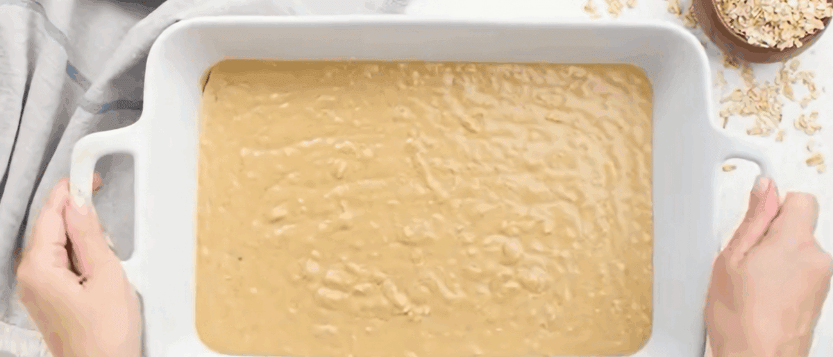 Oatmeal cake batter in a white baking dish.
