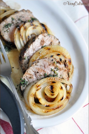 Pork tenderloin is grilled in a peppercorn and garlic marinade, then topped with a dab of herb butter, for an easy and delicious summertime meal.