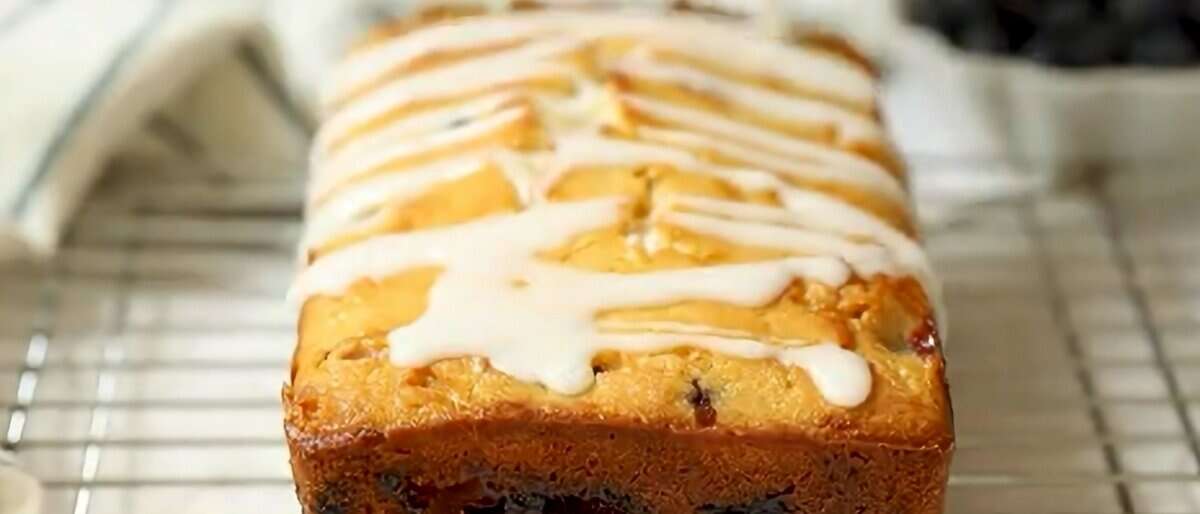 Drizzling the glaze over the bread.