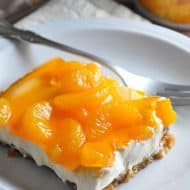 Mandarin Orange Pretzel Dessert - This classic dessert features a crunchy pretzel crust, a creamy center, and silky top with mandarin oranges and orange flavored gelatin. Perfect for a summer luncheon!