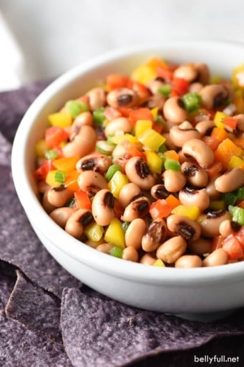 This Texas Caviar is a cross between a salad and a dip, made up of black-eyed peas and colorful bell peppers, lightly pickled in a vinaigrette dressing and served with blue corn tortilla chips!