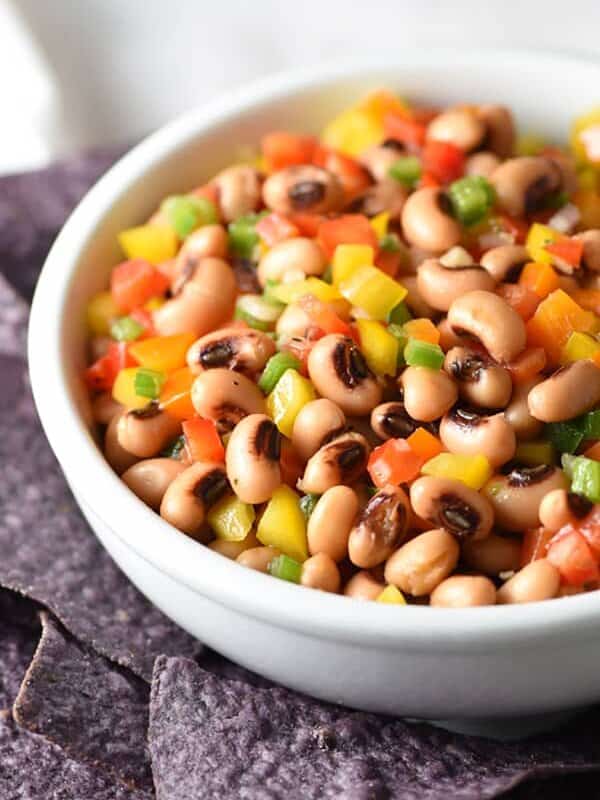 This Texas Caviar is a cross between a salad and a dip, made up of black-eyed peas and colorful bell peppers, lightly pickled in a vinaigrette dressing and served with blue corn tortilla chips!