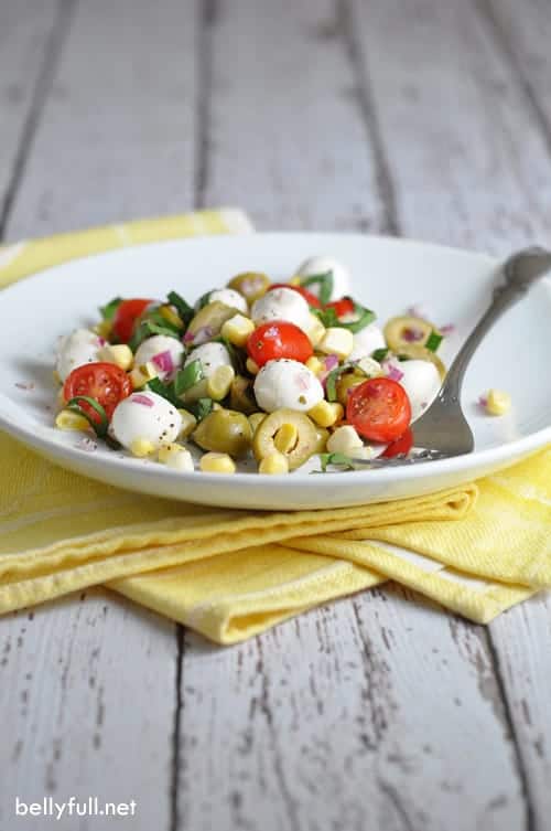 Caprese Corn Salad - no cooking required in this simple and absolutely wonderful salad! Made with sweet tomatoes, salty olives, fresh corn, and tangy vinegar.