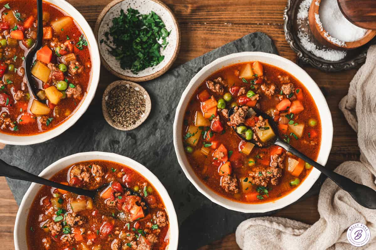 Chuck wagon stew simmering with potatoes, vegetables, and beef in a rich tomato broth.