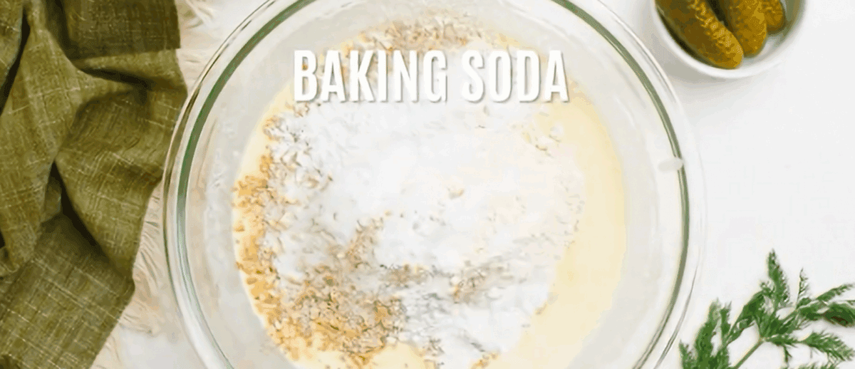 Adding dry ingredients to the bowl of wet ingredients.