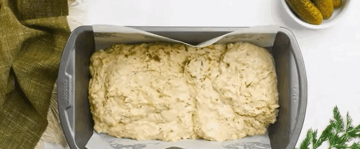 Spreading the batter into a lined loaf pan.