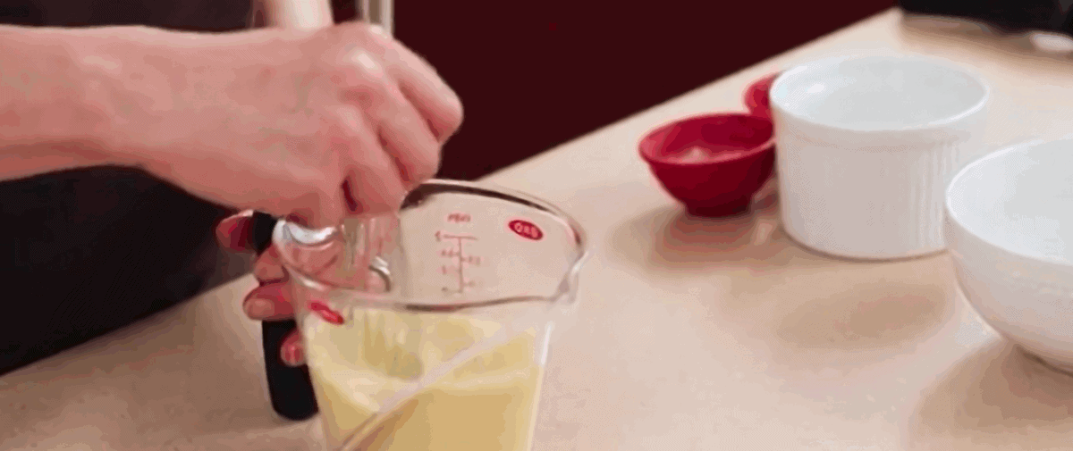 Combining wet ingredients in a glass measuring cup.