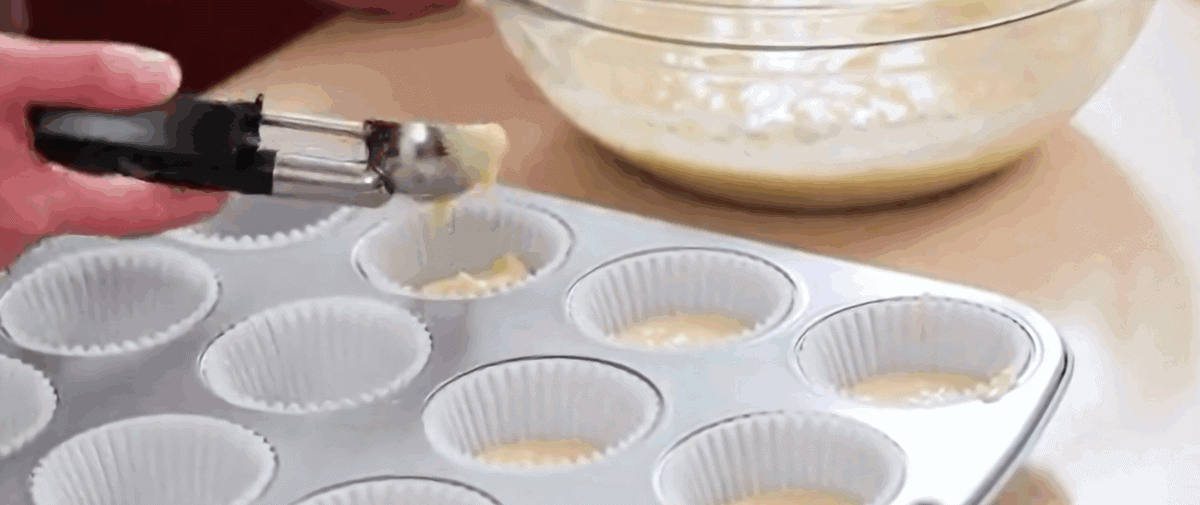 Dividing the batter into the muffin cups.