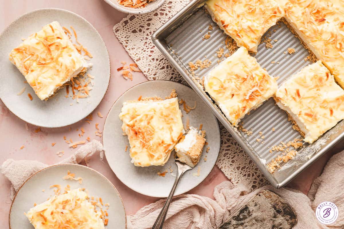 This Coconut Cream Lush is smooth, rich, light, and there’s no cooking involved. It’s so easy and perfect for summer gatherings! Overhead view of coconut cream lush slices on plates