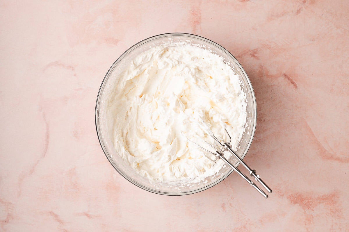 This Coconut Cream Lush is smooth, rich, light, and there’s no cooking involved. It’s so easy and perfect for summer gatherings! Homemade whipped cream in a bowl
