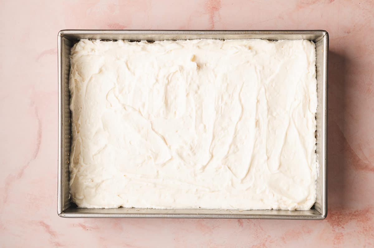 This Coconut Cream Lush is smooth, rich, light, and there’s no cooking involved. It’s so easy and perfect for summer gatherings! The mixture spread in the pan