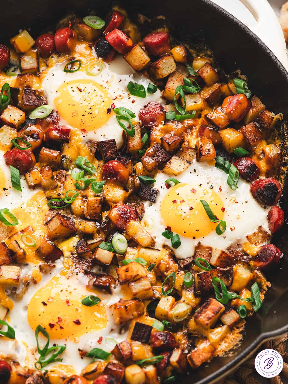 Smoked sausage, diced potatoes, egg, and cheese make this Skillet Breakfast Hash an easy, savory, and hearty breakfast. Overhead view of skillet breakfast hash