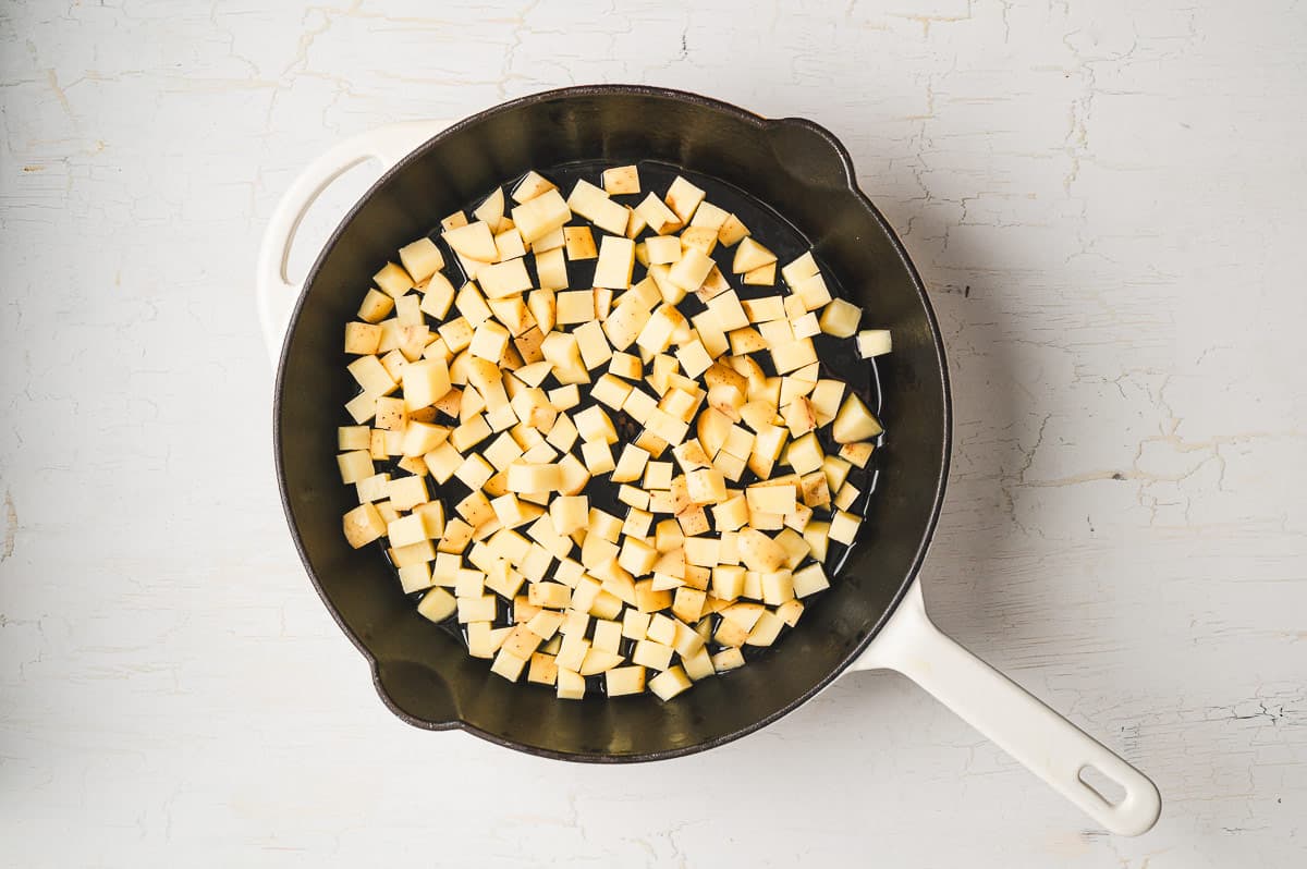 Smoked sausage, diced potatoes, egg, and cheese make this Skillet Breakfast Hash an easy, savory, and hearty breakfast. Diced potatoes in a cast iron skillet