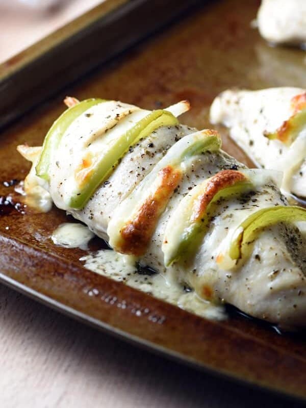 How fun is this Philly Cheese Steak Hasselback Chicken?! Slices of provolone cheese, bell pepper, and onion get stuffed into pockets of seasoned chicken breasts, then baked. The results are moist and delicious! Super easy weeknight meal.
