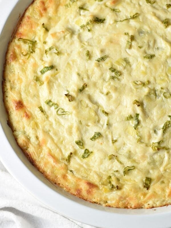 This is the best Artichoke Dip, with artichokes, Sriracha, Parmesan and Gruyere cheeses. Perfect for get togethers or game day!