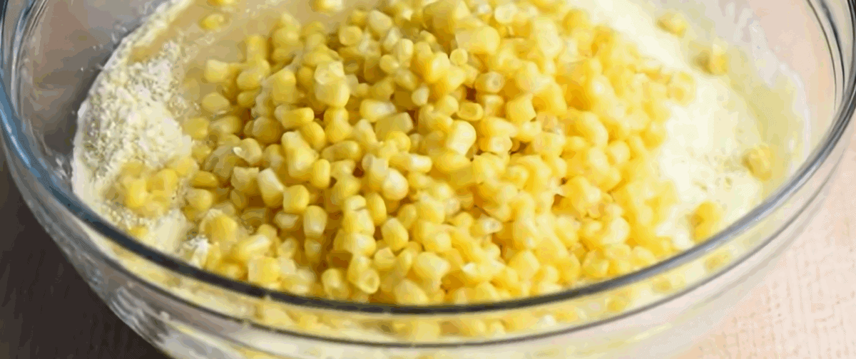 Ingredients for cornbread casserole in a glass bowl.