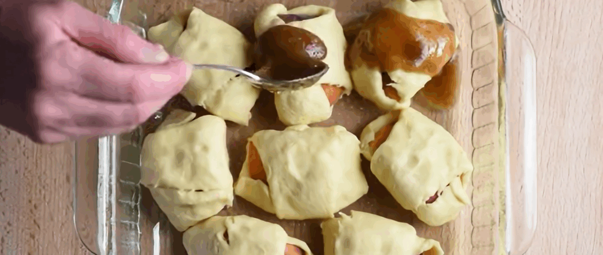 Drizzling the butter and brown sugar mixture over the dumplings.