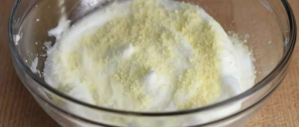 Egg whites with Parmesan cheese in a glass bowl.