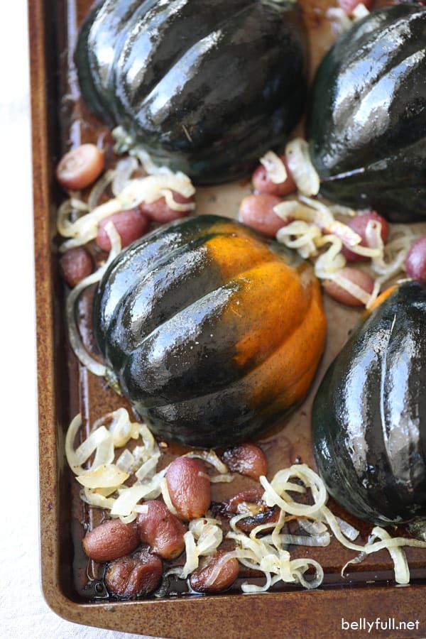 roasted winter squash halves on a baking sheet