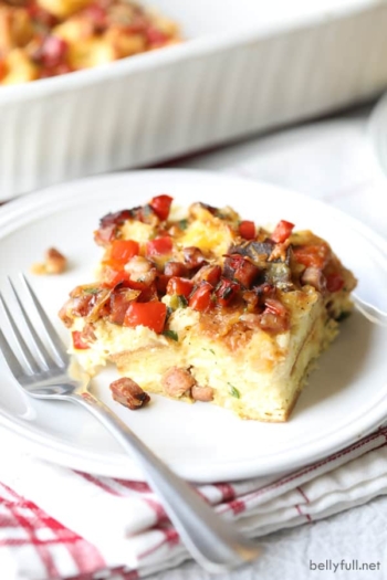 piece of ham breakfast casserole on white plate with fork