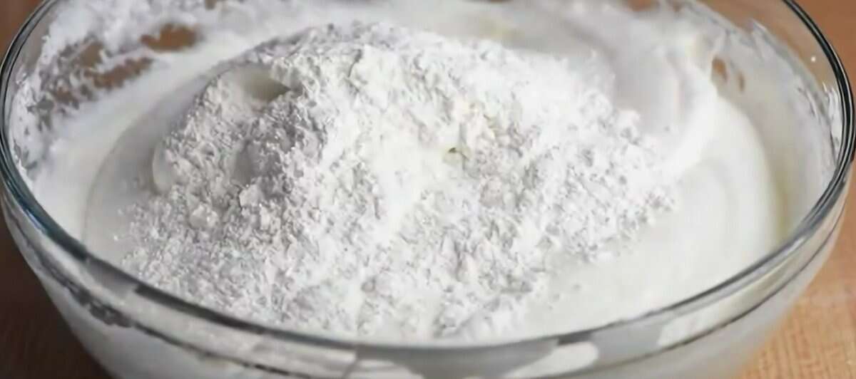 Adding flour to the egg mixture.