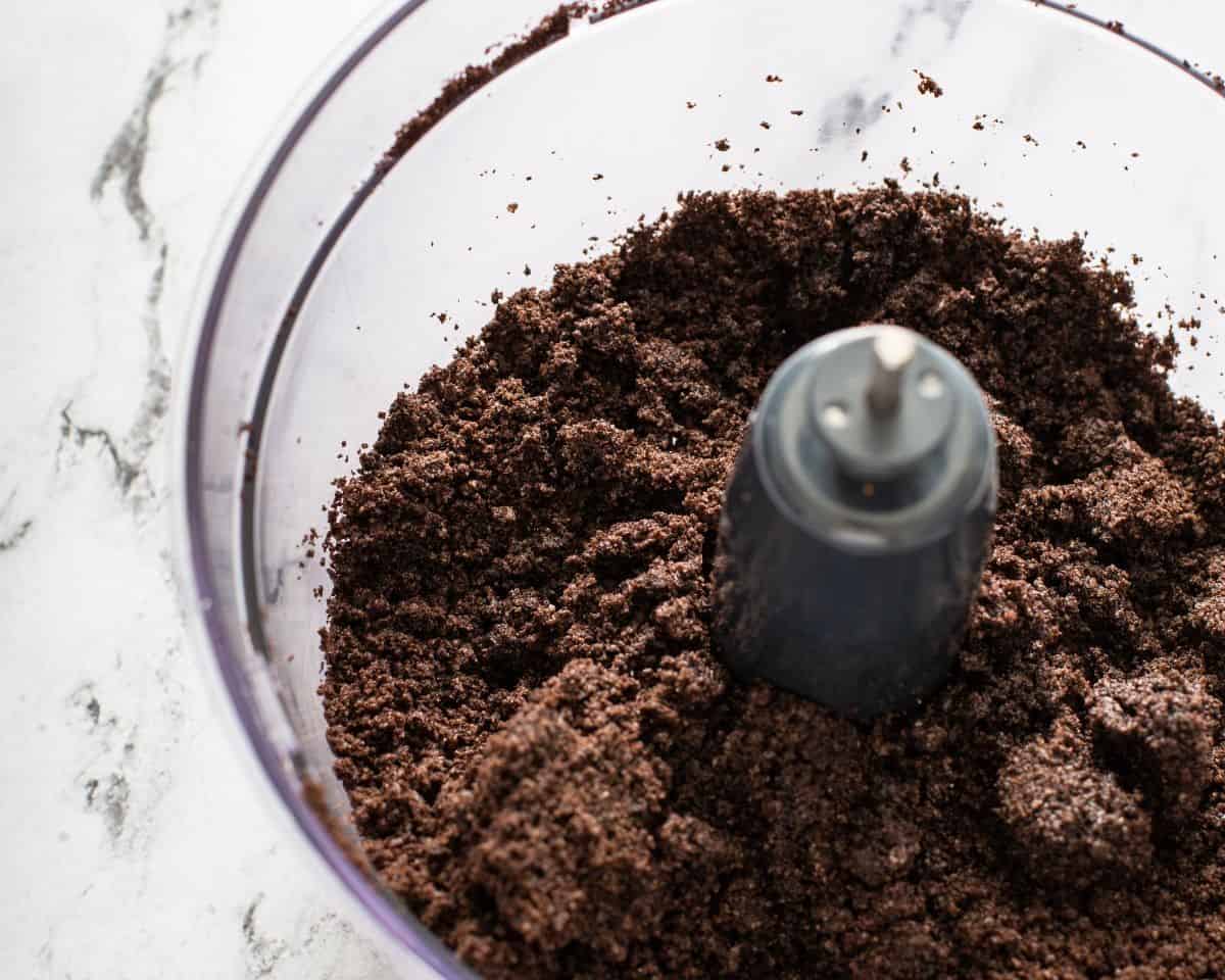 Processing Oreo cookies into crumbs in the food processor.