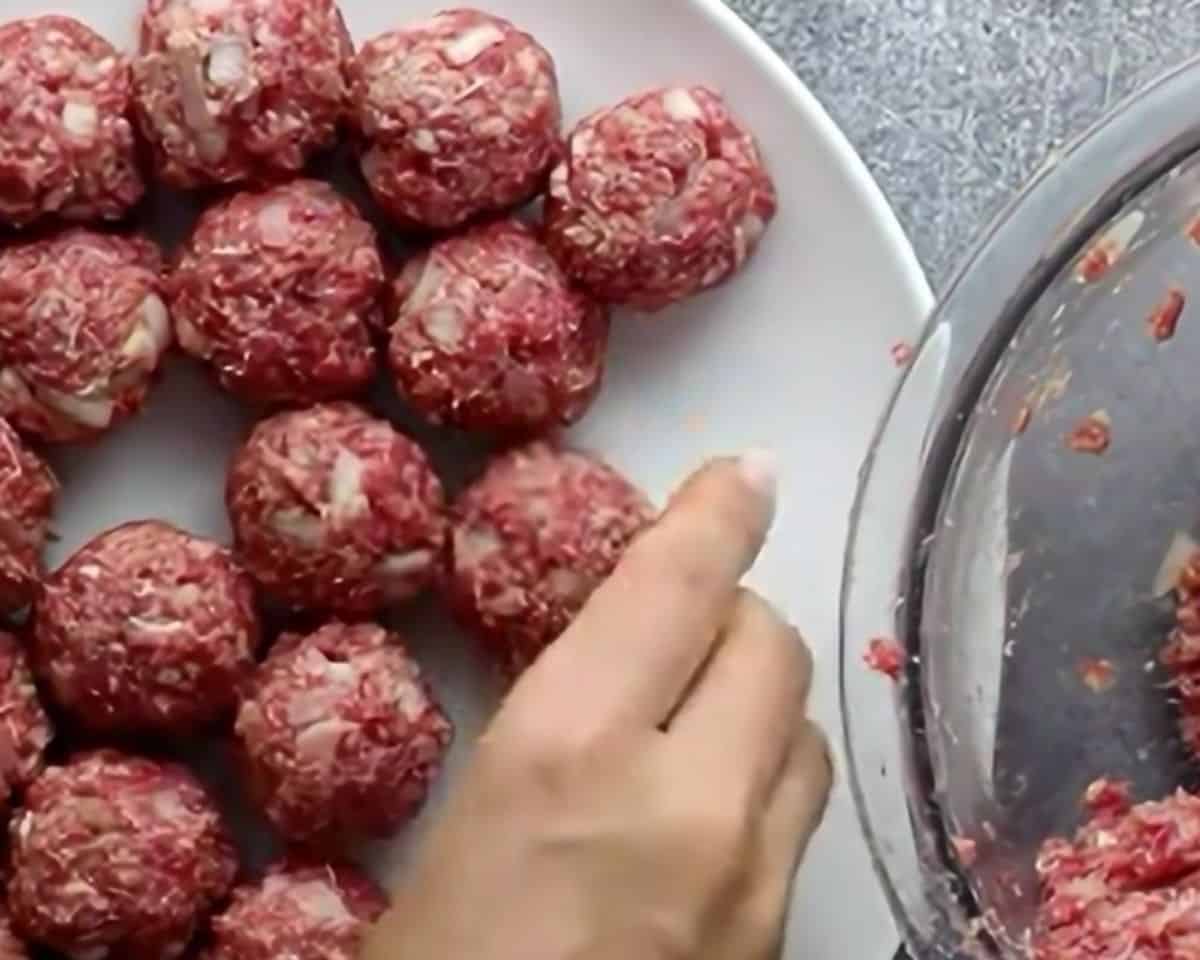 Shaping the meatballs.