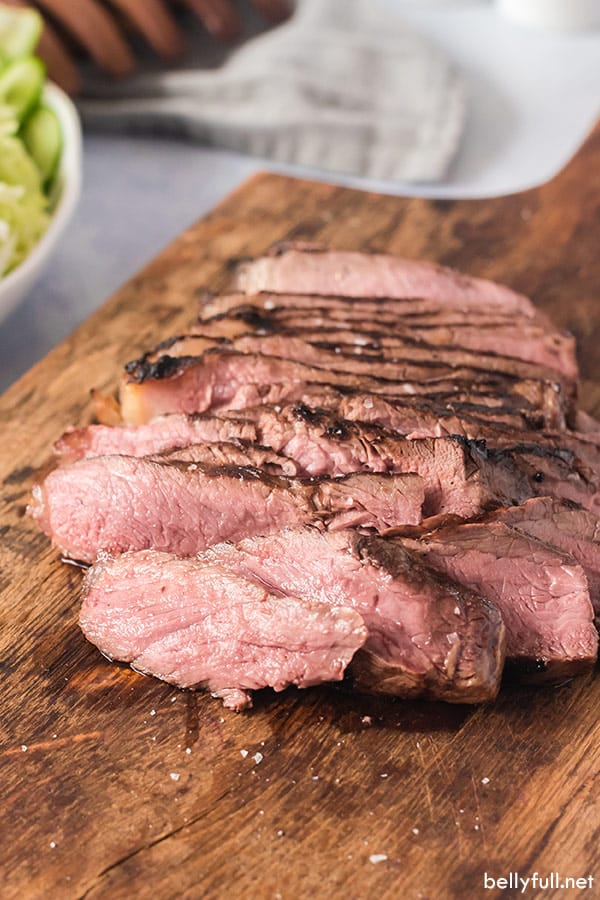 sliced grilled steak on cutting board