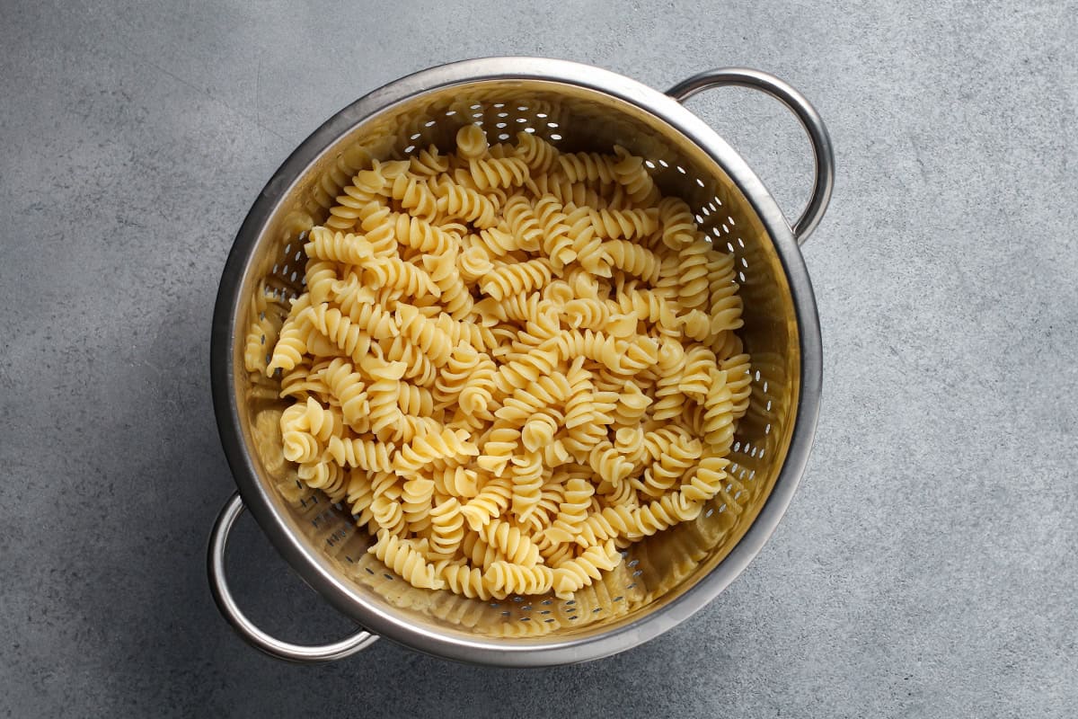 Cooked pasta in a colander.