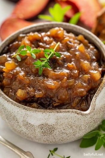 close up picture of onion jam in brown speckled serving bowl