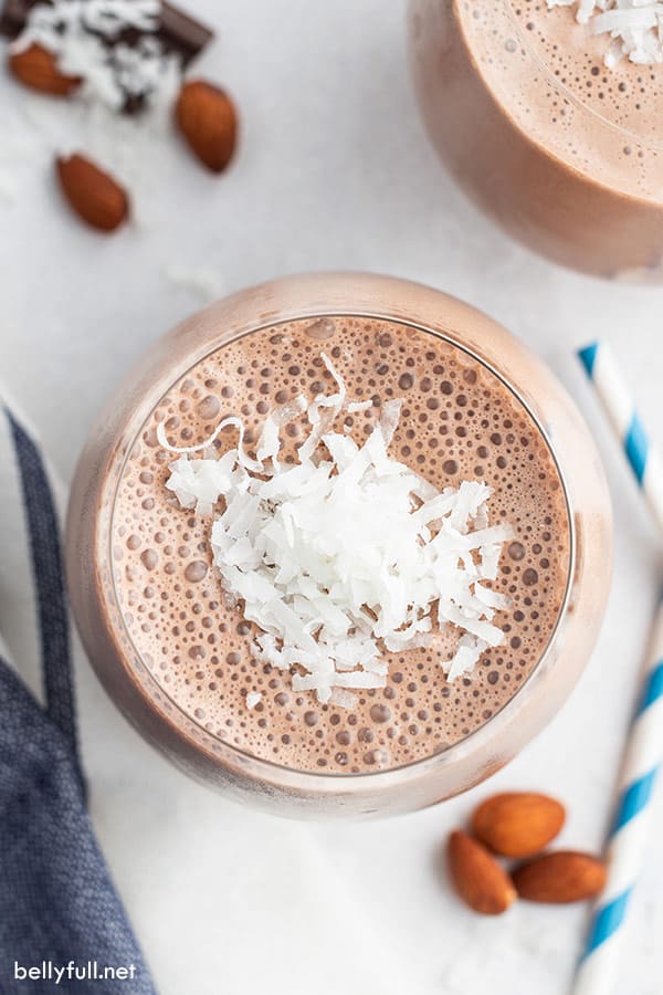 overhead of almond joy smoothie with shredded coconut flakes