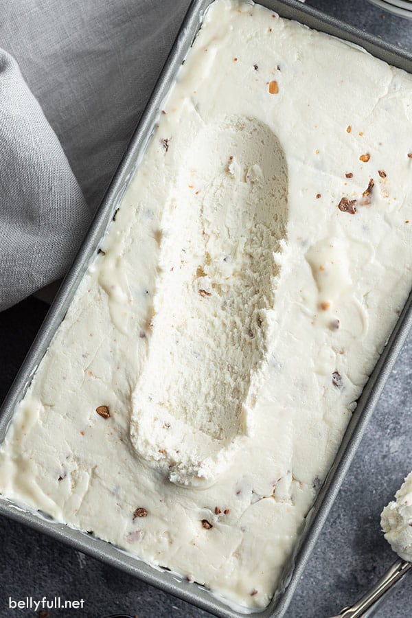 overhead picture of toffee vanilla ice cream in loaf pan with portion missing