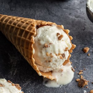 scoop of toffee chocolate no churn ice cream in waffle cone on its side