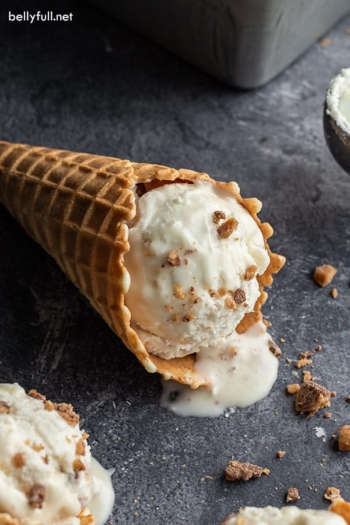 scoop of toffee chocolate no churn ice cream in waffle cone on its side