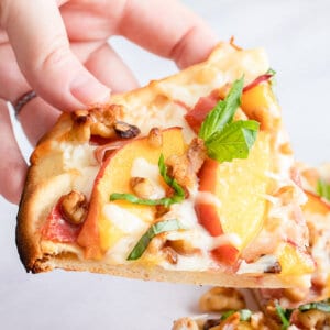 slice of flatbread pizza with coppa and peaches