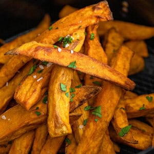 cooked sweet potato fries in air fryer basket