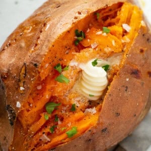 overhead of baked sweet potato split open with a dap of butter