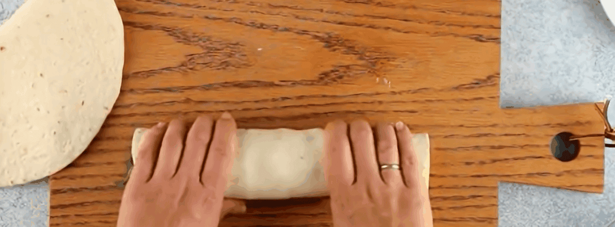 Rolling up the tortilla.