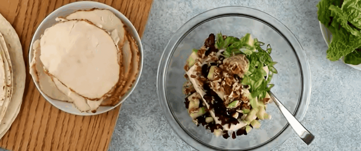 Combining cream cheese with the add-ins for chicken salad pinwheels.