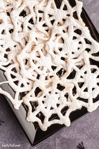 closeup overhead of black serving tray filled with spiderweb cookies