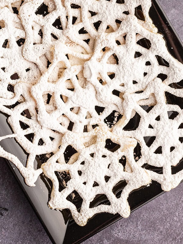 closeup overhead of black serving tray filled with spiderweb cookies