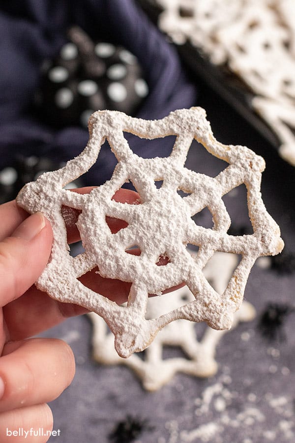 close up of hand holding cobweb Halloween cookie