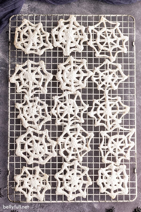 overhead picture of 15 cobweb cookies on baking rack